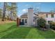 Backyard features a grassy lawn and the exterior of the home at 185 Willow Stream Ct, Roswell, GA 30076