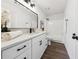 Modern bathroom with white vanity, black hardware, and a shower-tub combination at 185 Willow Stream Ct, Roswell, GA 30076