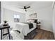 Bright bedroom features a ceiling fan, plush rug, and natural light from the window at 185 Willow Stream Ct, Roswell, GA 30076