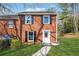 Charming brick two-story home with black shutters and a well-manicured front yard at 185 Willow Stream Ct, Roswell, GA 30076