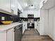 Modern kitchen features quartz countertops, stainless steel appliances, white cabinetry, and a stylish backsplash at 185 Willow Stream Ct, Roswell, GA 30076