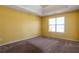 Bright bedroom featuring a tray ceiling, neutral carpet, and natural light at 4183 Ward Lake Trl, Ellenwood, GA 30294