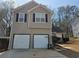 Two story home featuring an attached two car garage, black shutters, and a driveway at 4183 Ward Lake Trl, Ellenwood, GA 30294