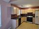 Well-equipped kitchen featuring wooden cabinets, appliances, and tile flooring at 4183 Ward Lake Trl, Ellenwood, GA 30294