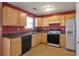 Well-equipped kitchen featuring wooden cabinets, appliances, and tile flooring at 4183 Ward Lake Trl, Ellenwood, GA 30294