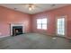 Cozy living room featuring a fireplace, ceiling fan, and access to the backyard at 4183 Ward Lake Trl, Ellenwood, GA 30294