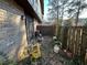 Backyard featuring a brick wall, sliding glass doors, and yard equipment at 1411 Brixton Cir, Stone Mountain, GA 30083