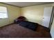 Bedroom features yellow walls, a window, a door, carpet, and a ceiling border at 1411 Brixton Cir, Stone Mountain, GA 30083