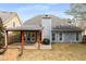 View of the back of the home with a covered patio, well-kept lawn and mature landscaping at 2859 Royal Blf, Decatur, GA 30030