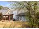 Back exterior of home, featuring covered patio, well-kept lawn and mature landscaping at 2859 Royal Blf, Decatur, GA 30030