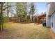 View of the backyard featuring a well-maintained lawn, garden, and covered patio at 2859 Royal Blf, Decatur, GA 30030