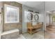 Bathroom boasts double sink, marble counters, wood cabinets, and tile shower with bench at 2859 Royal Blf, Decatur, GA 30030