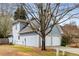 Side view of this lovely home, showing the two-car garage, siding, and mature landscaping at 2859 Royal Blf, Decatur, GA 30030