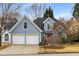 Lovely two-story home featuring a two-car garage, well-kept lawn, and a welcoming red front door at 2859 Royal Blf, Decatur, GA 30030