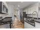 Bright kitchen with black countertops, stainless steel appliances, and a stainless steel sink at 2859 Royal Blf, Decatur, GA 30030