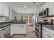 Bright kitchen featuring white cabinets, stainless steel appliances, and wood-look flooring at 2859 Royal Blf, Decatur, GA 30030