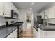 Well-lit kitchen with white cabinets, stainless steel appliances, and modern fixtures at 2859 Royal Blf, Decatur, GA 30030