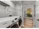 Laundry room with modern washer/dryer, shelving, and view into a naturally lit room at 2859 Royal Blf, Decatur, GA 30030