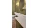 Green bathroom with toilet, light, and vanity with marble countertop at 3196 Andrews Nw Ct, Atlanta, GA 30305