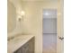 Bathroom featuring gray vanity with white countertops, illuminated by decorative sconce lighting at 3196 Andrews Nw Ct, Atlanta, GA 30305