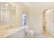 Bathroom with a marble vanity top, window, toilet, and open door at 3196 Andrews Nw Ct, Atlanta, GA 30305