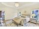 Bright bedroom with tray ceiling, a decorative mirror, and plush bedding at 3196 Andrews Nw Ct, Atlanta, GA 30305