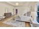 Bedroom featuring tray ceiling, wood floors, and cozy decor at 3196 Andrews Nw Ct, Atlanta, GA 30305