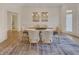 Bright dining room with white walls, modern chandelier, and a large area rug at 3196 Andrews Nw Ct, Atlanta, GA 30305