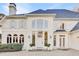 Elegant white home featuring arched windows, shutters, and manicured landscaping at 3196 Andrews Nw Ct, Atlanta, GA 30305