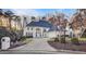 Grand home with a long driveway, mature landscaping, and a three-car garage at 3196 Andrews Nw Ct, Atlanta, GA 30305