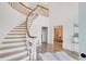 Bright foyer featuring a curved staircase, hardwood floors, and sophisticated design elements at 3196 Andrews Nw Ct, Atlanta, GA 30305