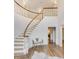 Welcoming foyer with a curved staircase, hardwood floors, and an elegant bench at 3196 Andrews Nw Ct, Atlanta, GA 30305