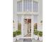 Beautiful home entrance with an open door framed by potted plants and decorative lanterns at 3196 Andrews Nw Ct, Atlanta, GA 30305