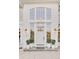 Classic home entrance with a decorative front door flanked by potted plants and stylish lanterns at 3196 Andrews Nw Ct, Atlanta, GA 30305