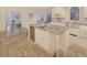 Beautiful kitchen island with wine cooler, granite countertops, and travertine flooring at 3196 Andrews Nw Ct, Atlanta, GA 30305