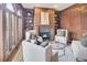 Traditional living room with a fireplace, wood paneling, built-in shelves, and large windows at 3196 Andrews Nw Ct, Atlanta, GA 30305