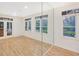 Bright living room featuring hardwood floors, large windows, and mirrored wall at 3196 Andrews Nw Ct, Atlanta, GA 30305