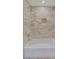 Close-up of a shower with neutral tiles and a built in niche at 3196 Andrews Nw Ct, Atlanta, GA 30305