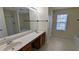 Bathroom featuring double sink vanity, soaking tub, and shower stall at 5928 Springfair Run, Lithonia, GA 30038