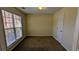 Cozy bedroom featuring neutral paint, carpet, window and a closet at 5928 Springfair Run, Lithonia, GA 30038