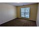 A standard bedroom with neutral walls, carpet flooring, and a window at 5928 Springfair Run, Lithonia, GA 30038