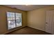 A standard bedroom with neutral walls, carpet flooring, and a window at 5928 Springfair Run, Lithonia, GA 30038