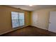 A standard bedroom with neutral walls, carpet flooring, and a window at 5928 Springfair Run, Lithonia, GA 30038