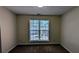 Carpeted bedroom with a window looking out into the neighborhood at 5928 Springfair Run, Lithonia, GA 30038