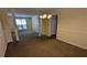 Open dining room features carpeted flooring, yellow walls, and column accents at 5928 Springfair Run, Lithonia, GA 30038