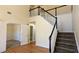 Bright foyer features hardwood floors and staircase to upper level of the home at 5928 Springfair Run, Lithonia, GA 30038