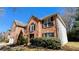 A view of a brick two story home with green bushes in front of the building at 5928 Springfair Run, Lithonia, GA 30038