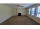 Bright living room featuring a fireplace, carpeted floors, neutral walls, and multiple windows at 5928 Springfair Run, Lithonia, GA 30038