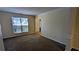 Sunlit living room featuring carpet floors, large window, and light yellow walls at 5928 Springfair Run, Lithonia, GA 30038