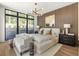 Modern bedroom featuring a wood slat wall, natural light and contemporary furnishings at 1131 Lupo Loop, Chattahoochee Hills, GA 30268